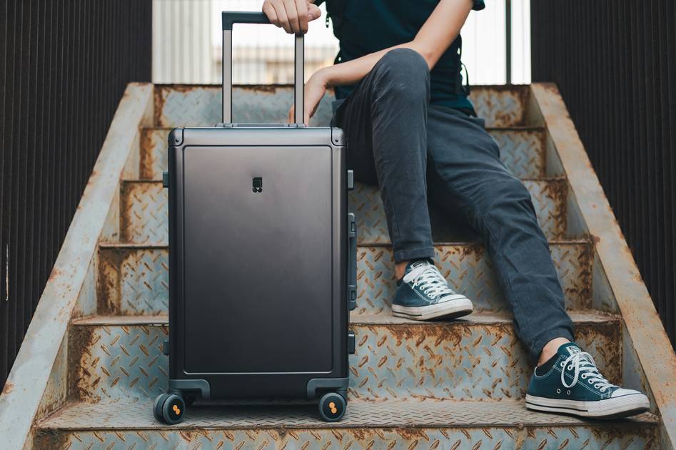 Sleek black hardshell suitcase on airport tarmac