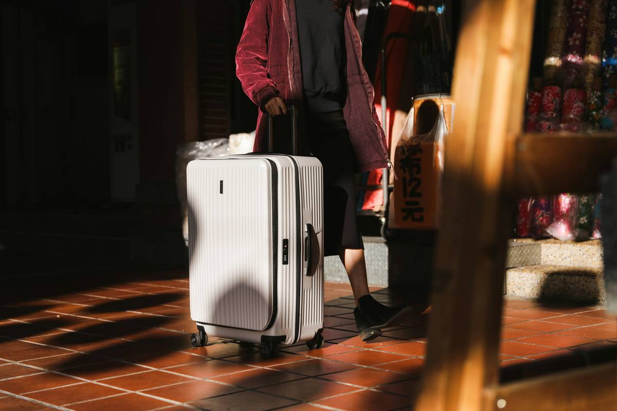 Close-up of jetsetter tough case bag with reinforced corners and spinner wheels on tarmac