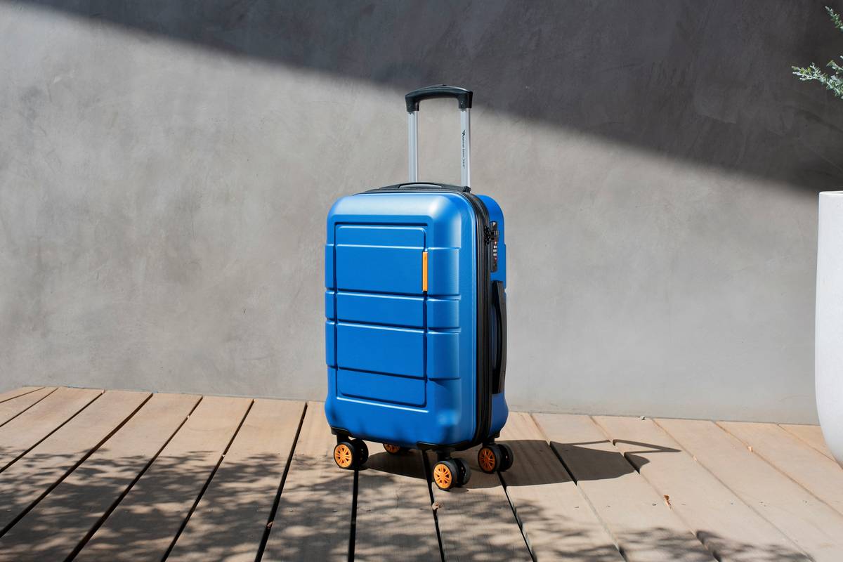 robust travel bag with scuff marks on airport tarmac showing durability